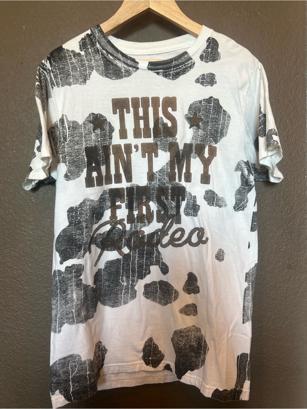 Buckle White Tee with Black Cow-Spot and Brown Rodeo Script